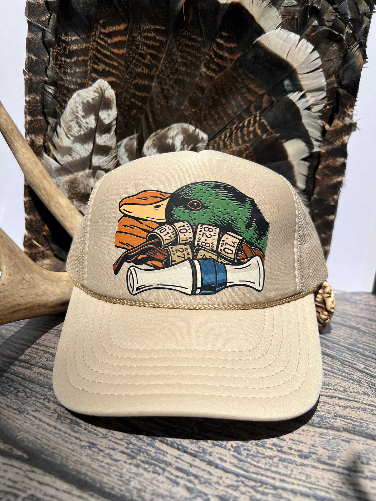 tan trucker hat with duck and duck call on it