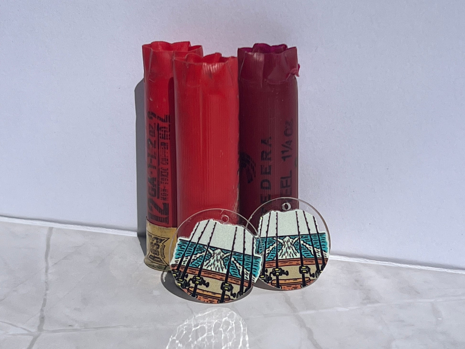 round earrings with fishing rods on boat