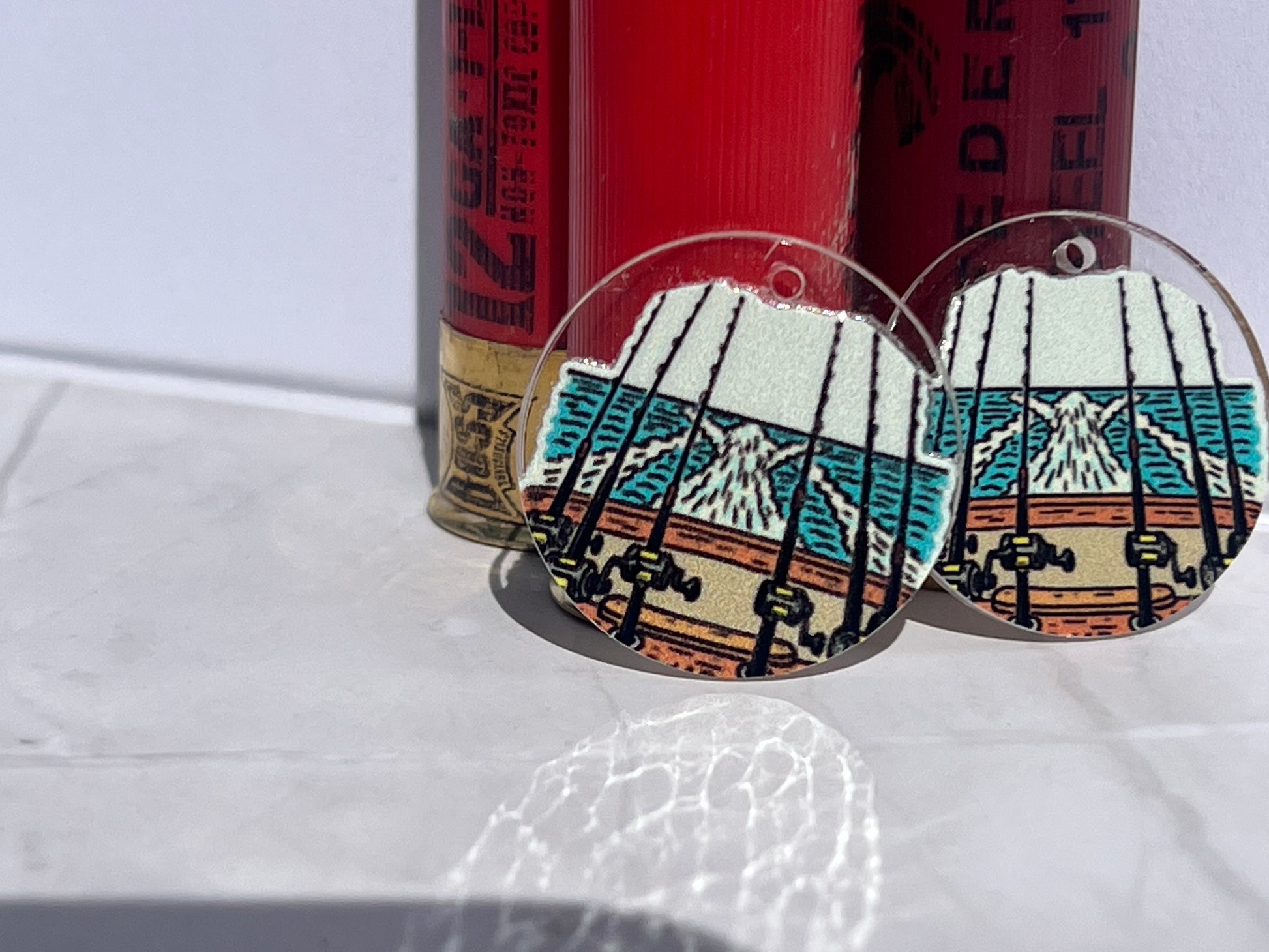 round earrings with fishing rods on boat