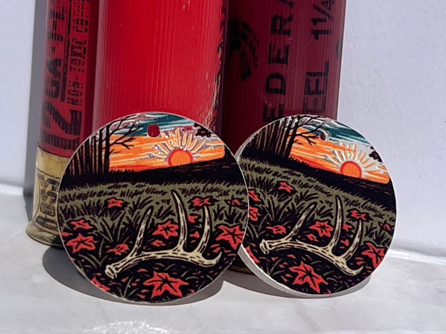 antler on ground with sunset on earring round acrylic piece