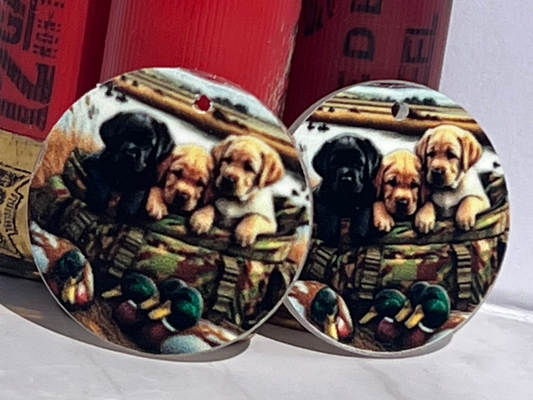 Round earrings with dog design on a white surface