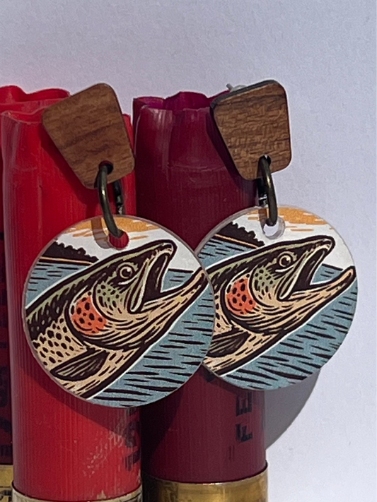 Fish-themed earrings displayed on red shotgun shells against a white background
